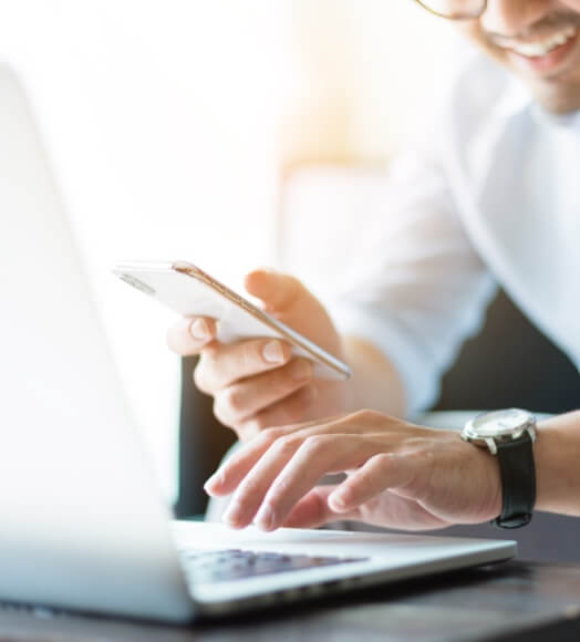 Man working on his phone to find his business healthcare savings